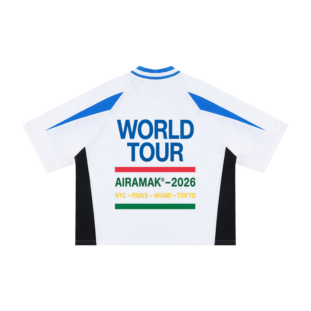 White jersey with blue accents, "World Tour AIRAMAK 2026" text, cities listed below.