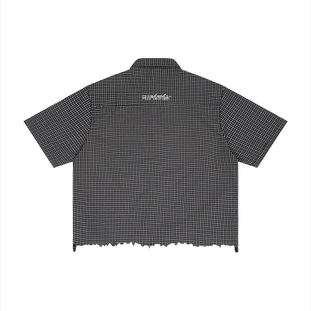 Checkered black shirt with short sleeves, frayed hem, and white text on the back.