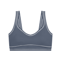 Gray sports bra with double straps and white trim accents.