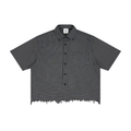 Checkered short-sleeve shirt with a frayed hem, front pocket, and button-up design in dark colors.