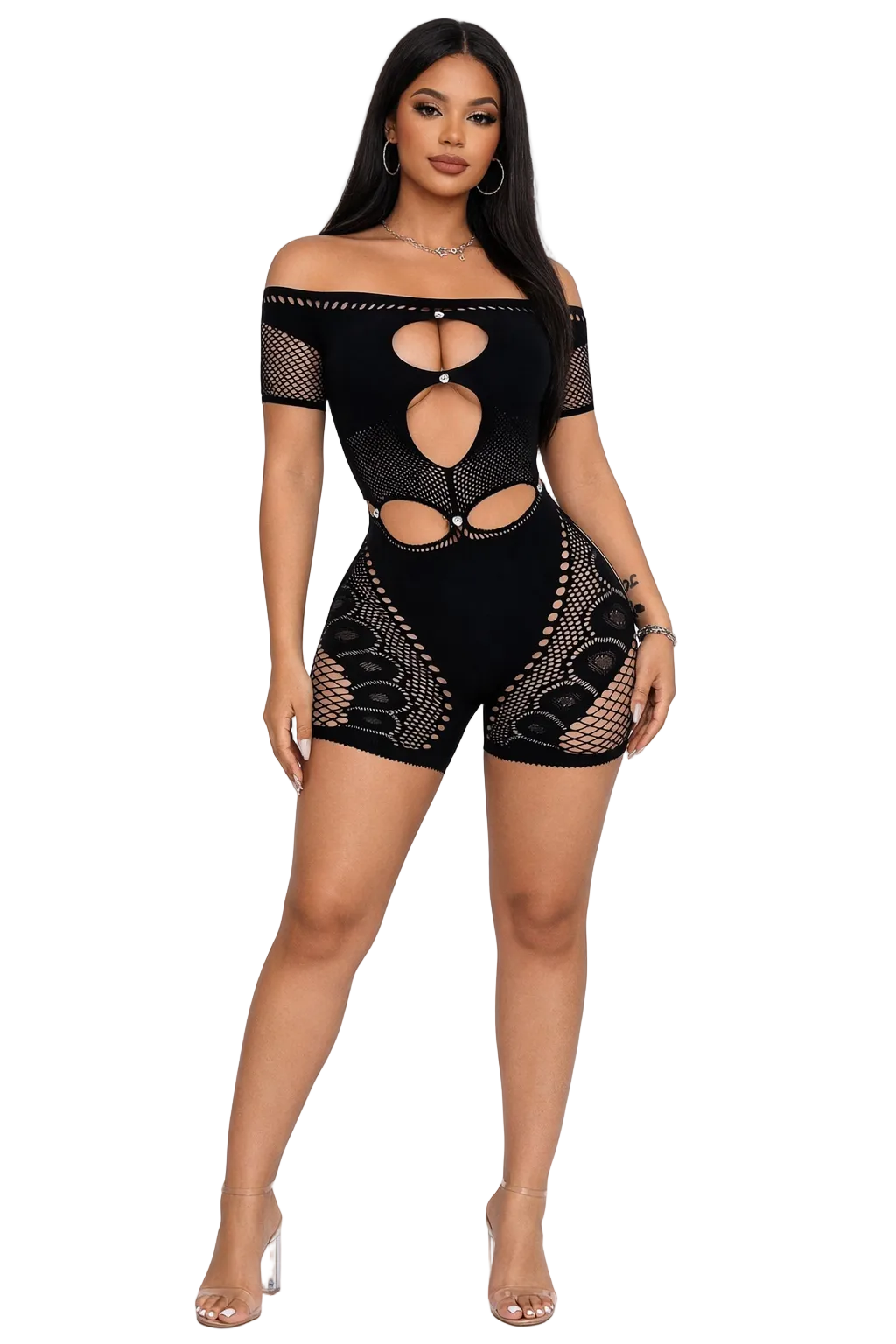 Woman in a black off-shoulder romper with cut-out patterns, wearing clear heels.