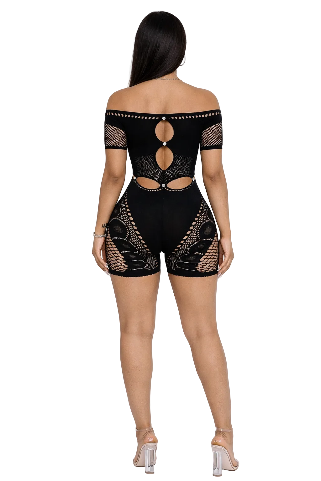 Woman in black off-shoulder bodysuit with cutouts and mesh patterns, clear high heels.