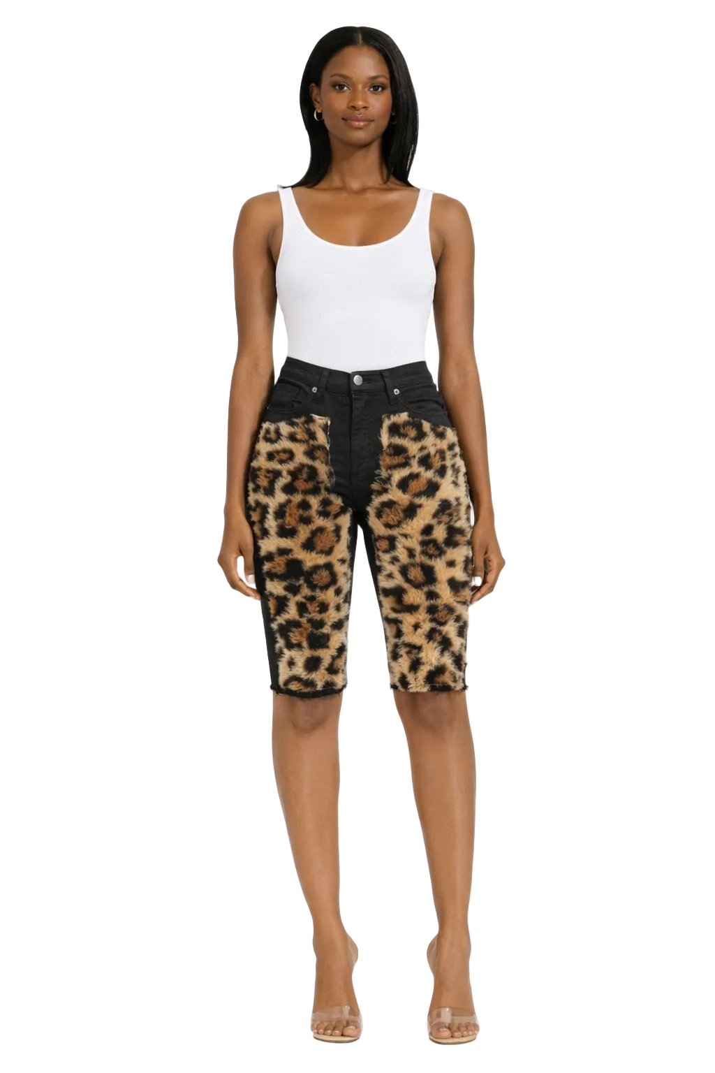 Woman in a white tank top and leopard print shorts with black waistband, wearing clear heels.