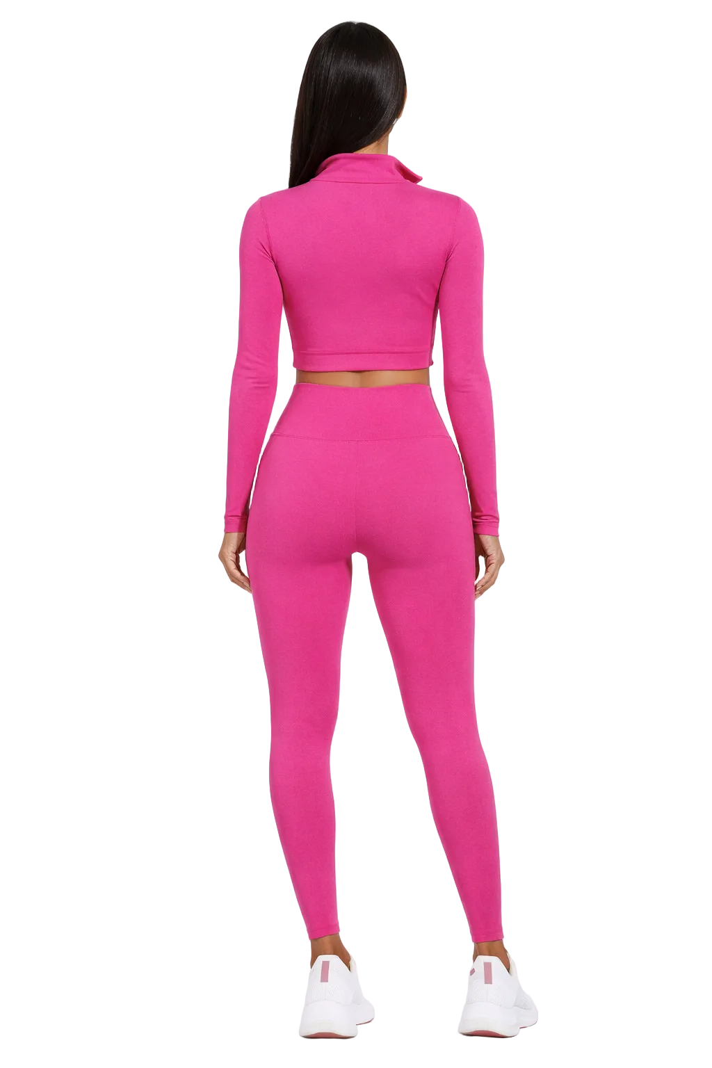 Woman in bright pink activewear set with long sleeves, viewed from the back, wearing white sneakers.
