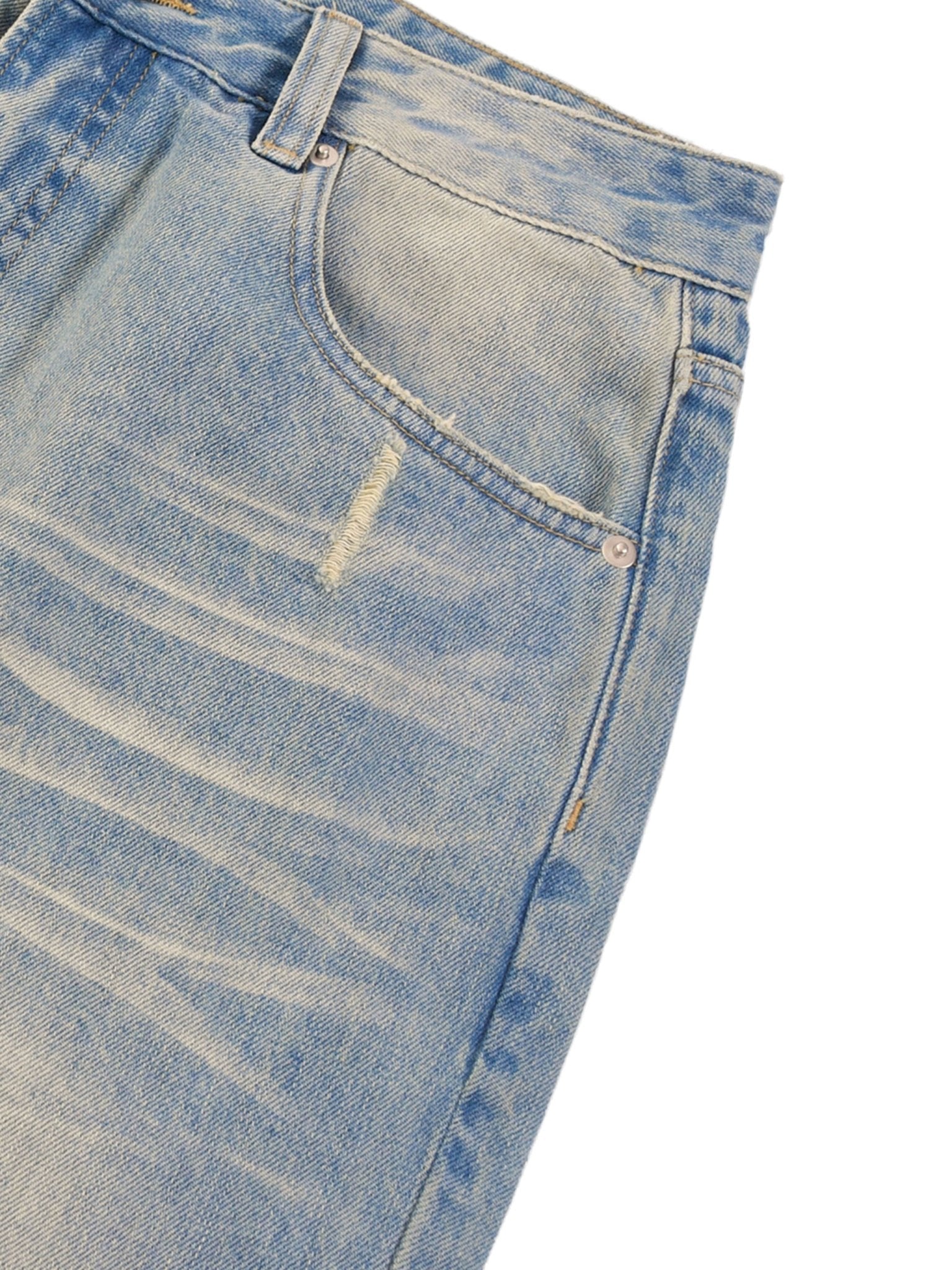 Close-up of light blue jeans with faded texture, front pocket, and belt loop visible.