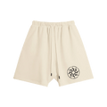 Cream shorts with elastic waistband and drawstrings, featuring a black circular logo on the left leg.
