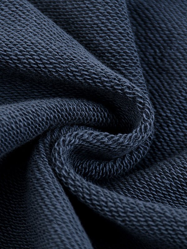 Close-up of dark blue textured fabric with a swirling pattern, showing intricate weave details.