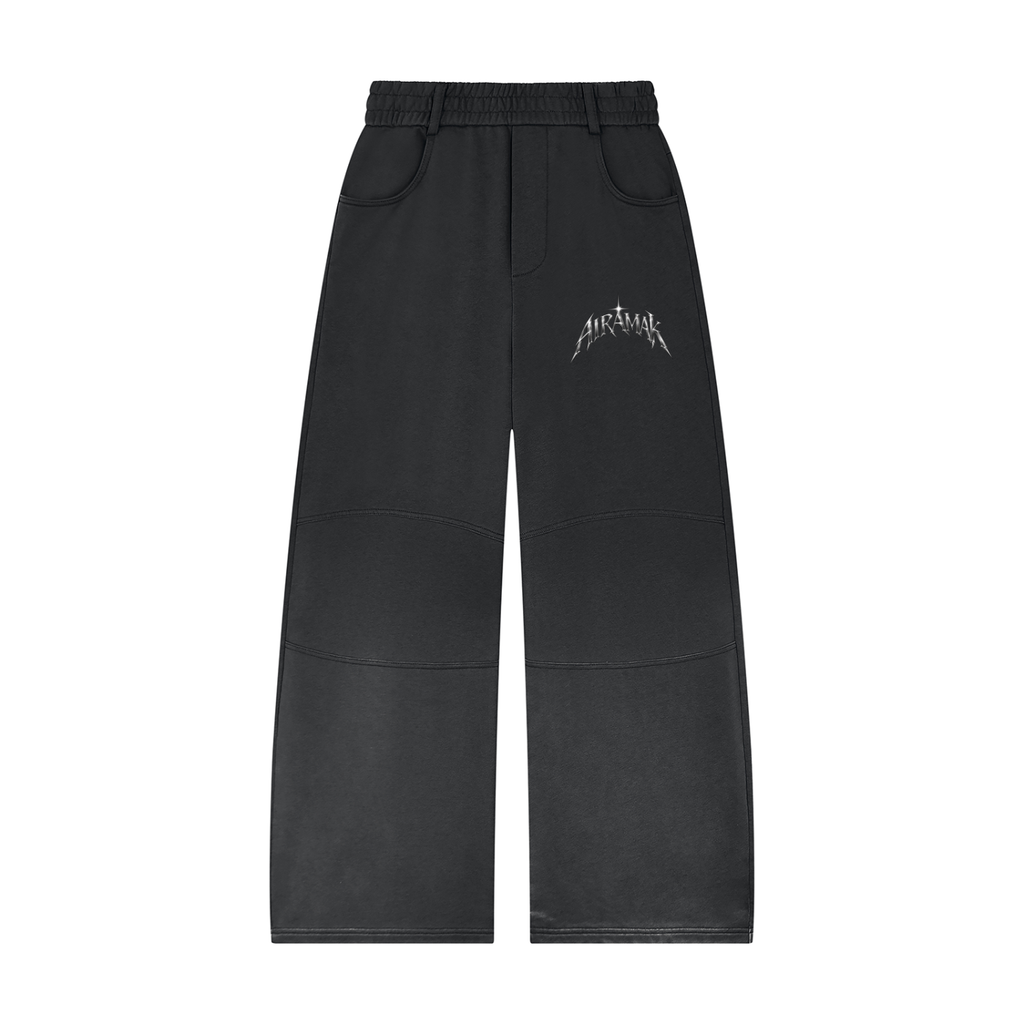Black wide-leg pants with white text on the thigh, featuring an elastic waistband and front pockets.