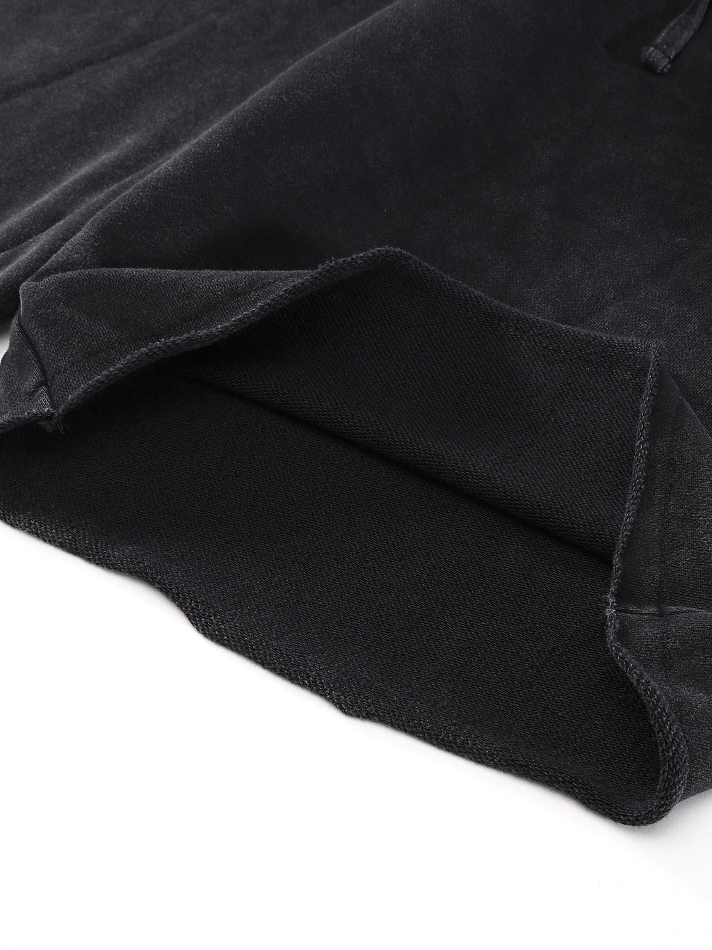 Close-up of black fabric with a folded edge, showing texture and stitching details.