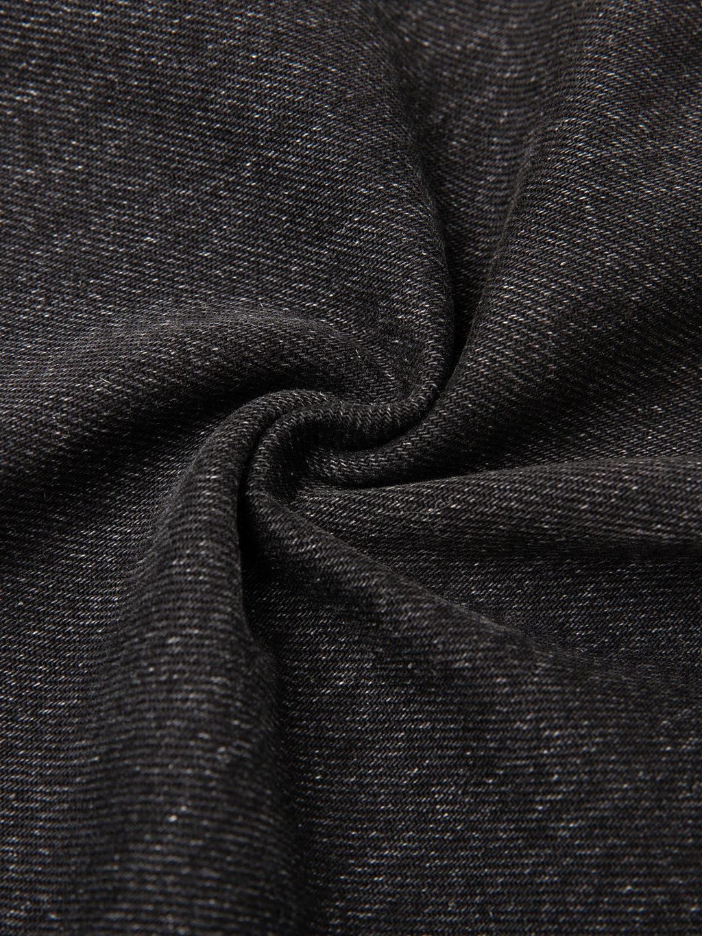 Dark gray fabric with subtle white speckles, twisted in the center forming a spiral pattern.