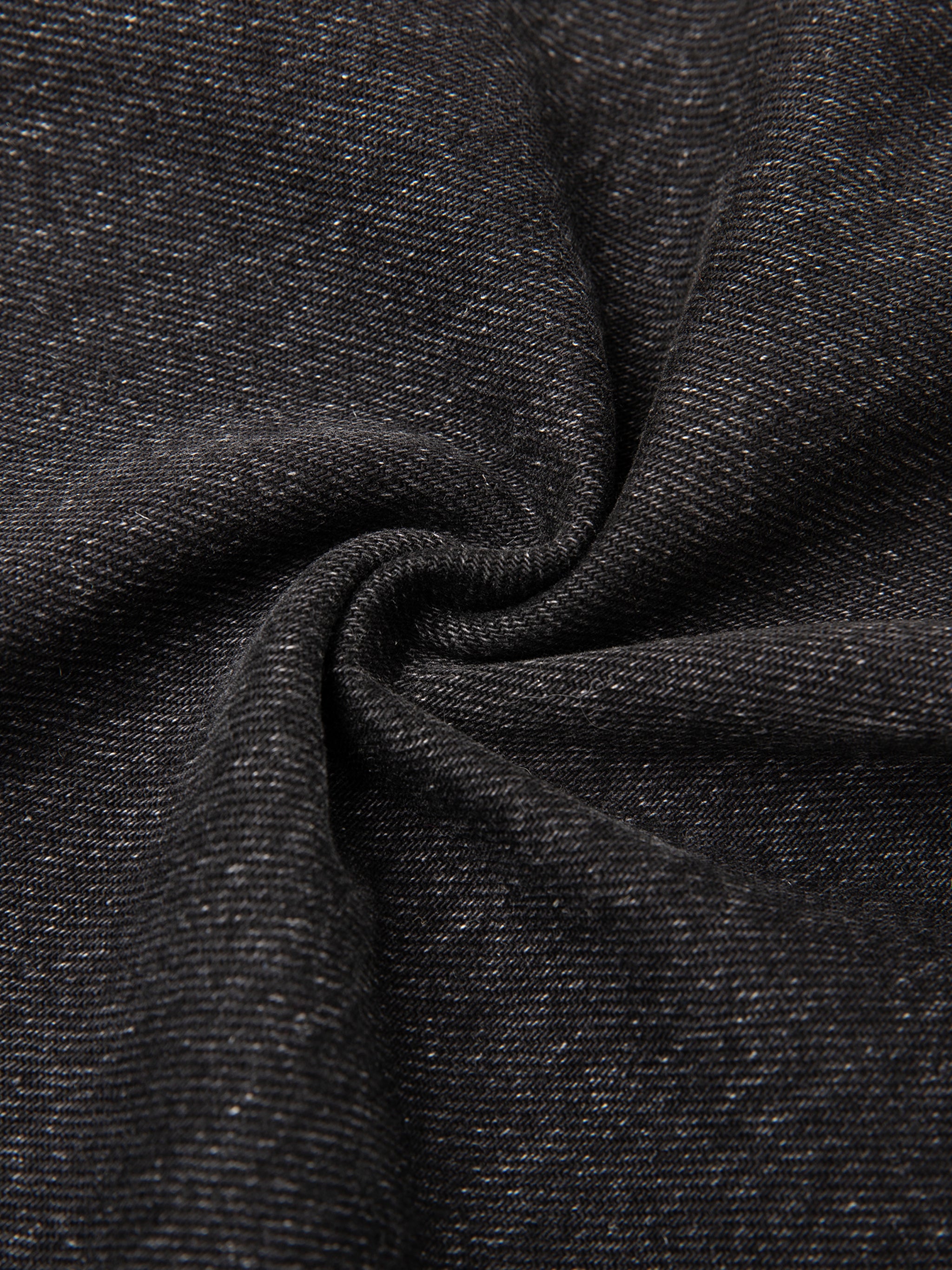Dark gray fabric with subtle white speckles, twisted in the center forming a spiral pattern.