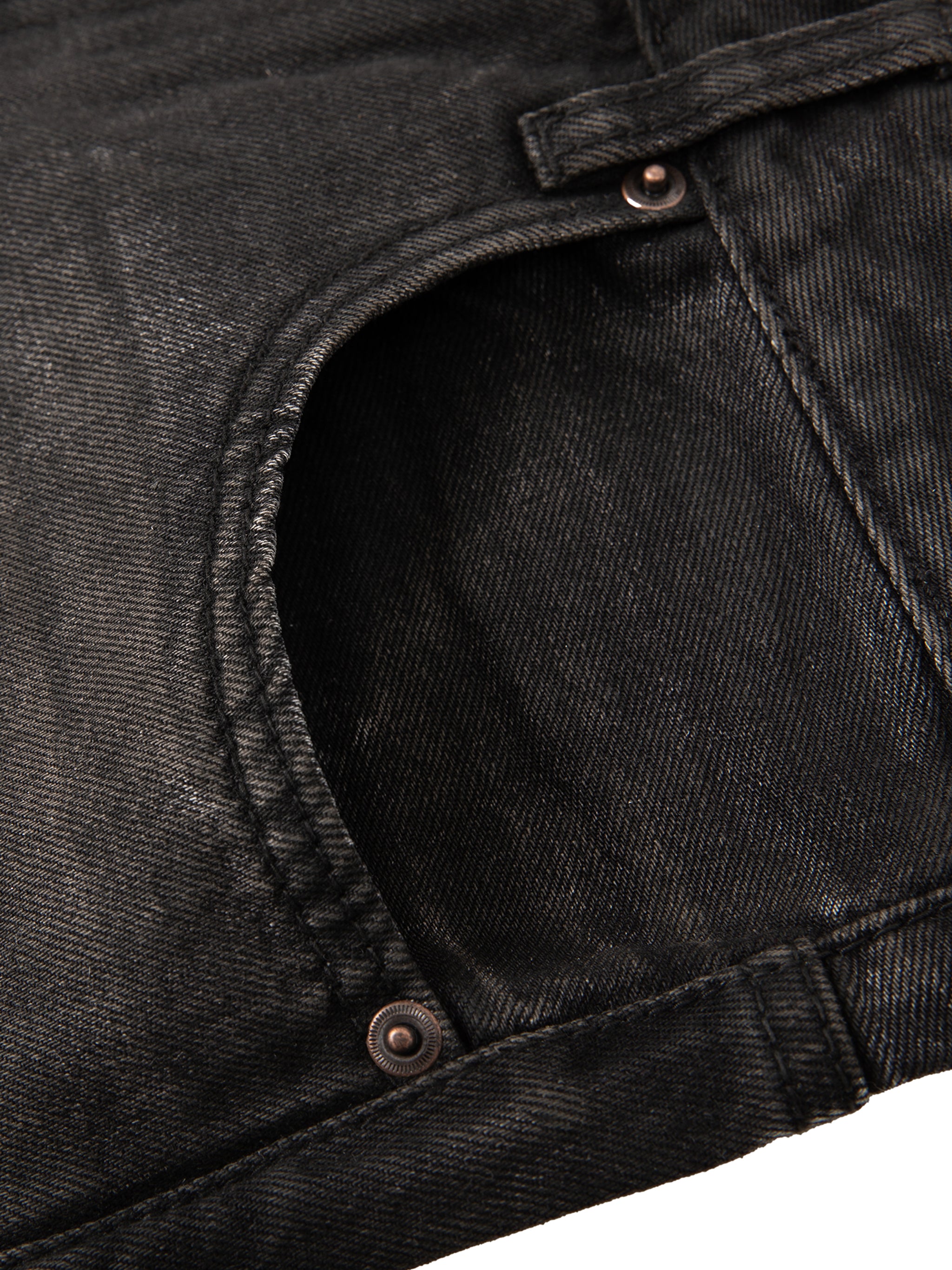 Close-up of a black denim pocket with rivets, showing texture and stitching details.