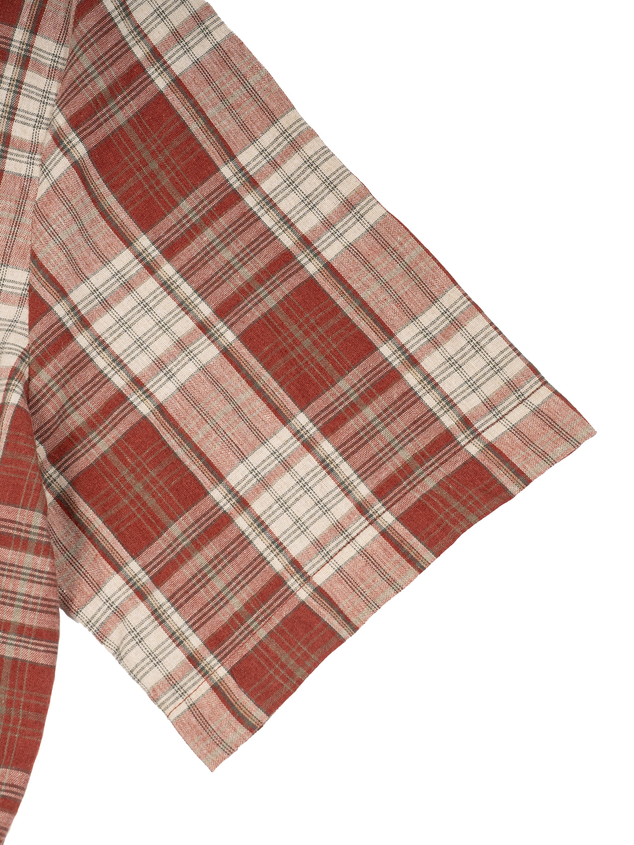 Red and beige plaid fabric with intersecting lines, featuring a sleeve with detailed pattern.